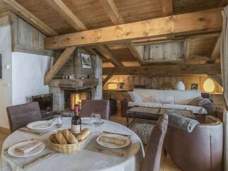 Experience the charm of this rustic retreat, featuring a cozy fireplace and exposed wooden beams.