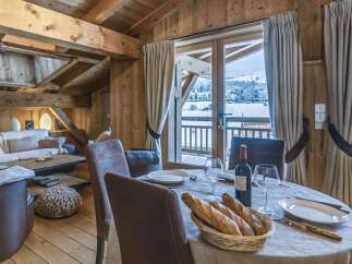 Experience the charm of this stunning chalet, boasting a cozy dining area with a breathtaking view.