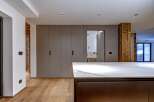 This modern kitchen boasts sleek cabinetry and a stunning marble countertop, perfect for culinary enthusiasts.