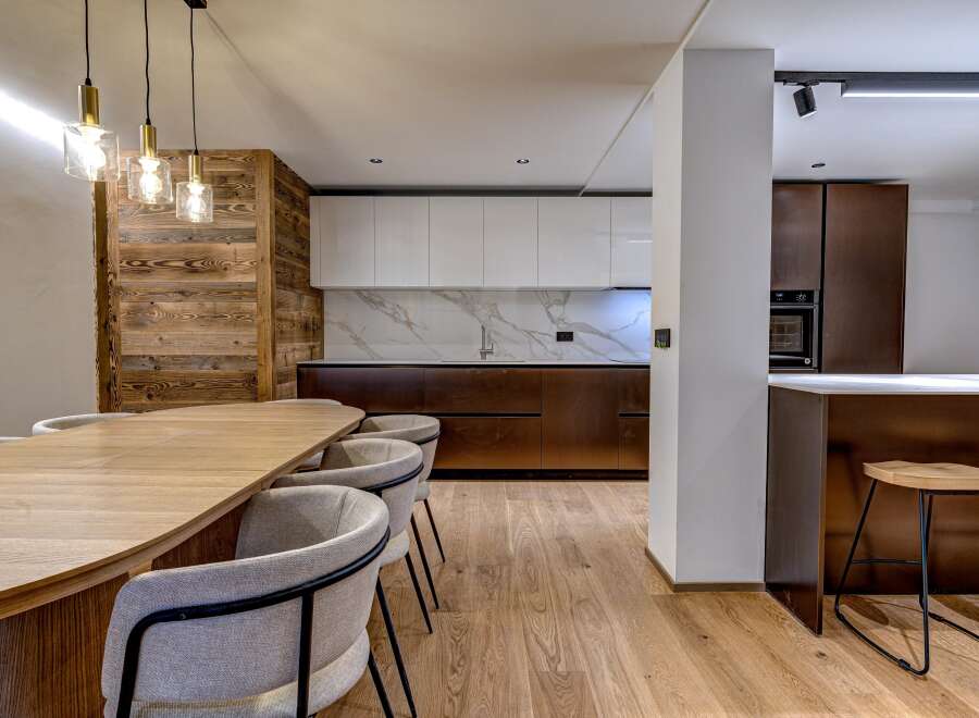 This stunning kitchen and dining area boasts a modern design with a touch of rustic charm.