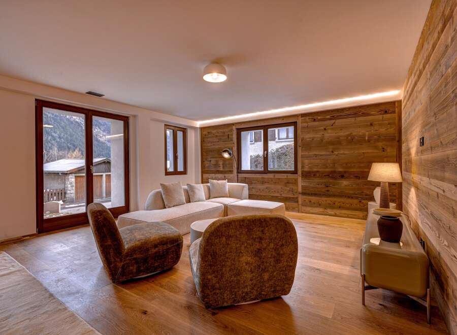 This stunning living room boasts a warm and inviting atmosphere, perfect for relaxation and entertaining.
