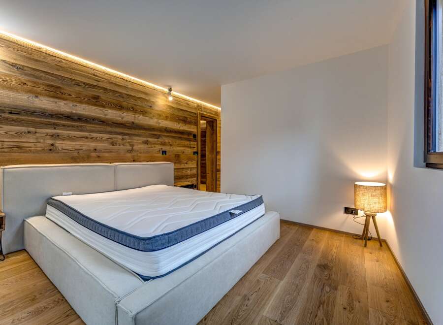 This stunning bedroom boasts a modern design with a warm, inviting ambiance.