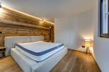 This stunning bedroom boasts a modern design with a warm, inviting ambiance.