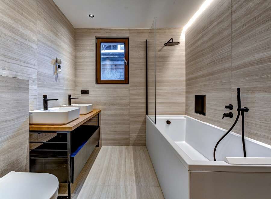 This modern bathroom showcases a sleek design with its neutral color palette and minimalist aesthetic.