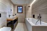 This modern bathroom showcases a sleek design with its neutral color palette and minimalist aesthetic.
