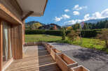Enjoy the tranquility of this stunning property, featuring a spacious wooden deck perfect for outdoor relaxation.
