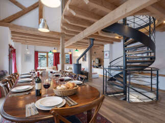 Experience luxury living in this stunning property featuring a spiral staircase and a spacious dining area.