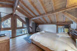 Experience the charm of this stunning bedroom with its rustic wooden beams and natural light.