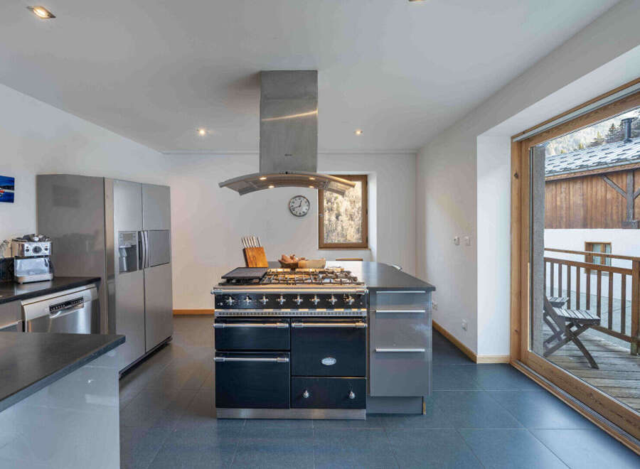 This stunning kitchen boasts a modern design with high-end appliances, perfect for culinary enthusiasts.