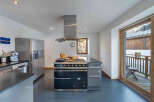 This stunning kitchen boasts a modern design with high-end appliances, perfect for culinary enthusiasts.