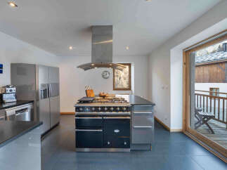 This stunning kitchen boasts a modern design with high-end appliances, perfect for culinary enthusiasts.