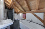 This stunning bathroom features a unique blend of rustic charm and modern design.