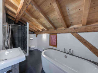 This stunning bathroom features a unique blend of rustic charm and modern design.