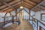 This stunning property boasts a unique architectural design with exposed wooden beams and a charming spiral staircase.
