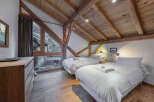 Experience the charm of this stunning bedroom, featuring exposed wooden beams and a cozy ambiance.