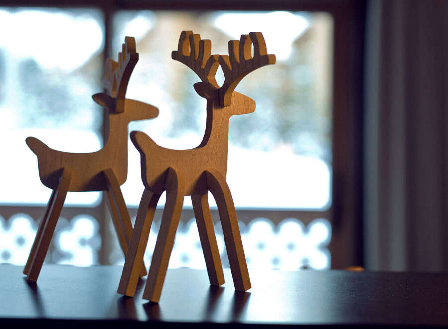Enhance your home decor with these charming wooden reindeer figurines.
