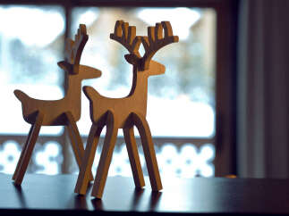 Enhance your home decor with these charming wooden reindeer figurines.
