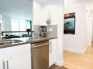 Discover modern living in this stylish kitchen! Featuring sleek stainless steel appliances, a contemporary sink, and ample counter space, this kitchen is perfect for both cooking and entertaining.