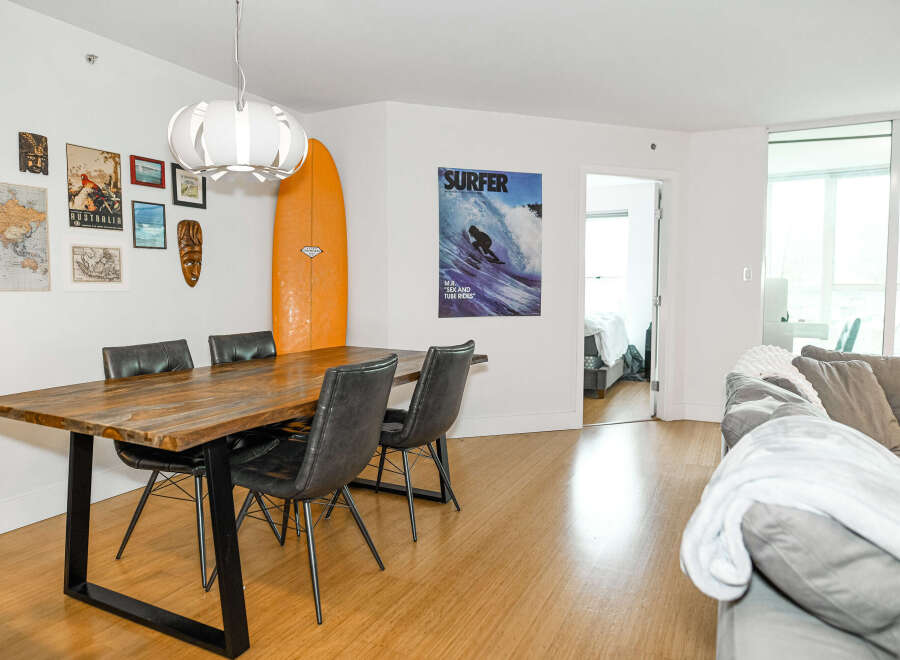 This stunning property features a modern dining area with a beautiful wooden table and stylish chairs, perfect for entertaining.