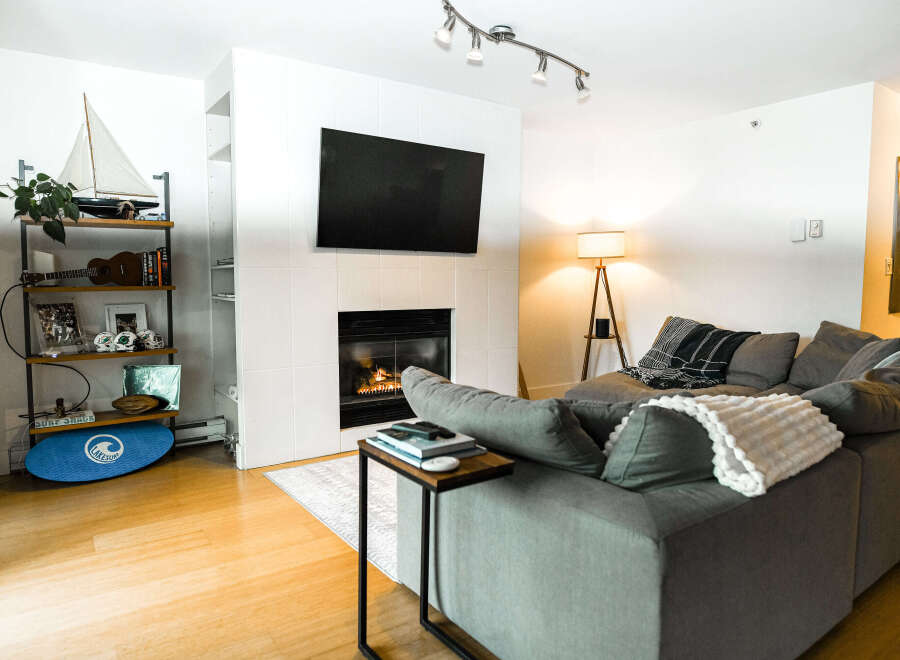 This stunning living room boasts a modern fireplace, perfect for cozy evenings.