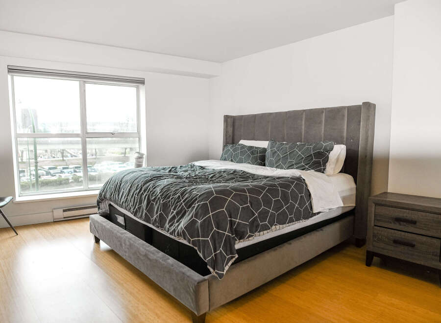 This modern bedroom boasts a stylish design with a comfortable bed as the centerpiece.