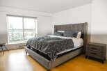 This modern bedroom boasts a stylish design with a comfortable bed as the centerpiece.
