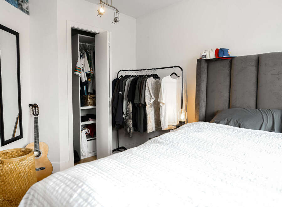 This stylish bedroom offers a serene retreat with its modern design and ample space.