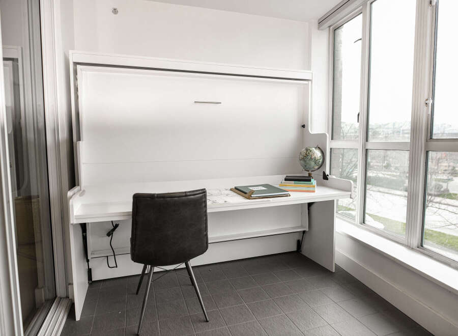 This modern condo features a stylish Murphy bed that doubles as a desk, perfect for maximizing space.