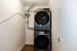 This modern laundry room features a sleek, stacked Samsung washer and dryer, maximizing space and efficiency.