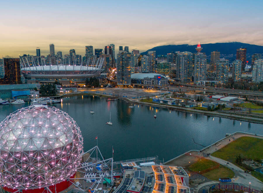 Experience the vibrant city life with this stunning aerial view of Vancouver, showcasing iconic landmarks like BC Place and Science World.