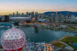 Experience the vibrant city life with this stunning aerial view of Vancouver, showcasing iconic landmarks like BC Place and Science World.