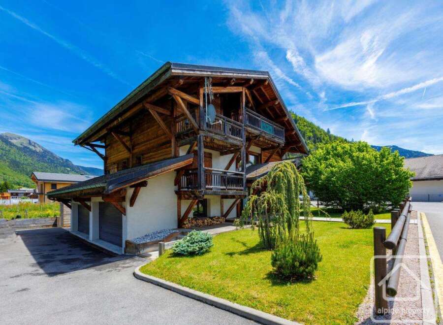 This stunning chalet boasts a classic alpine design with exposed wooden beams and a charming balcony.
