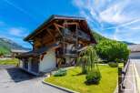 This stunning chalet boasts a classic alpine design with exposed wooden beams and a charming balcony.