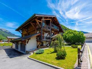 This stunning chalet boasts a classic alpine design with exposed wooden beams and a charming balcony.