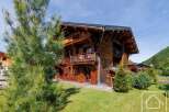 Discover the charm of this stunning wooden chalet nestled in a picturesque setting.