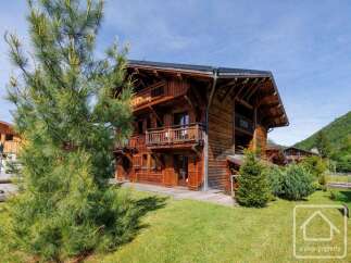 Discover the charm of this stunning wooden chalet nestled in a picturesque setting.