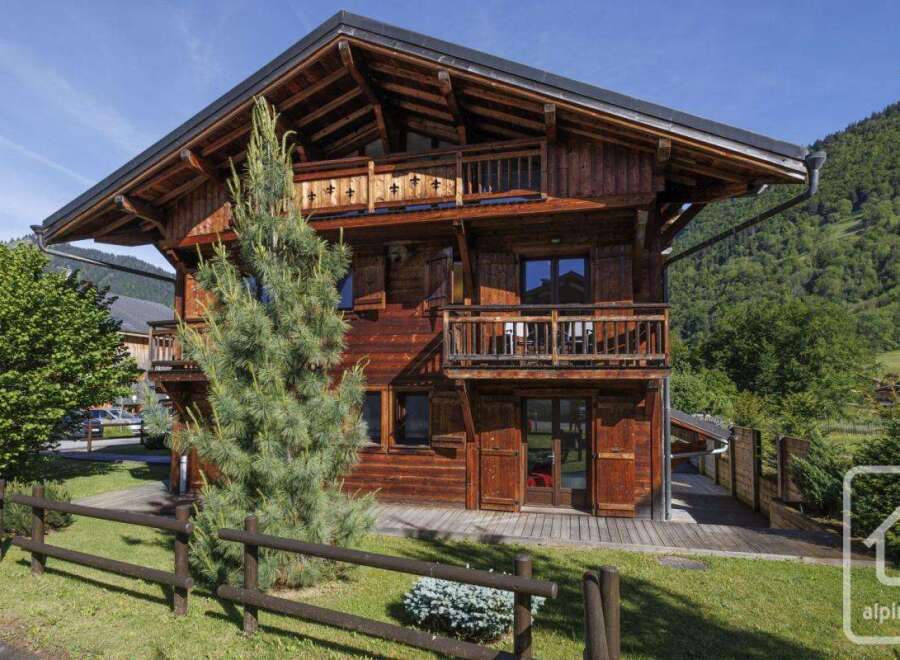 Discover the charm of this stunning wooden chalet nestled in a picturesque alpine setting.