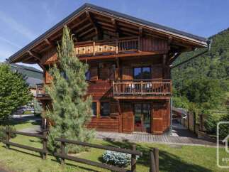 Discover the charm of this stunning wooden chalet nestled in a picturesque alpine setting.