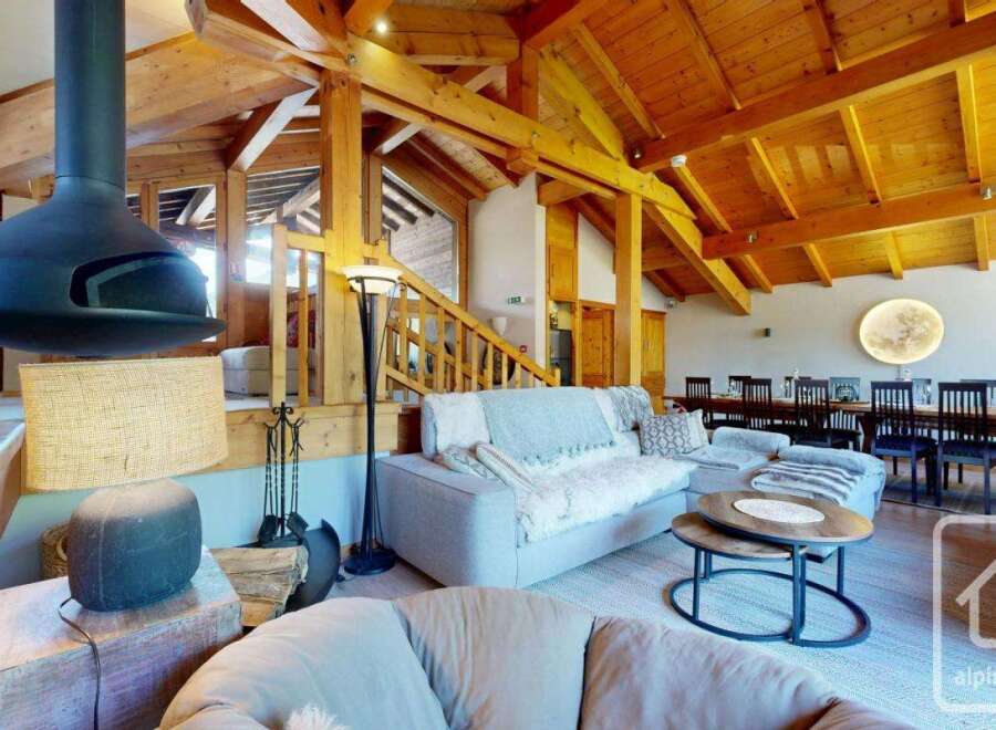 Experience luxury living in this stunning property, featuring a cozy living room with a unique fireplace and a comfortable seating area.
