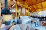 Experience luxury living in this stunning property, featuring a cozy living room with a unique fireplace and a comfortable seating area.