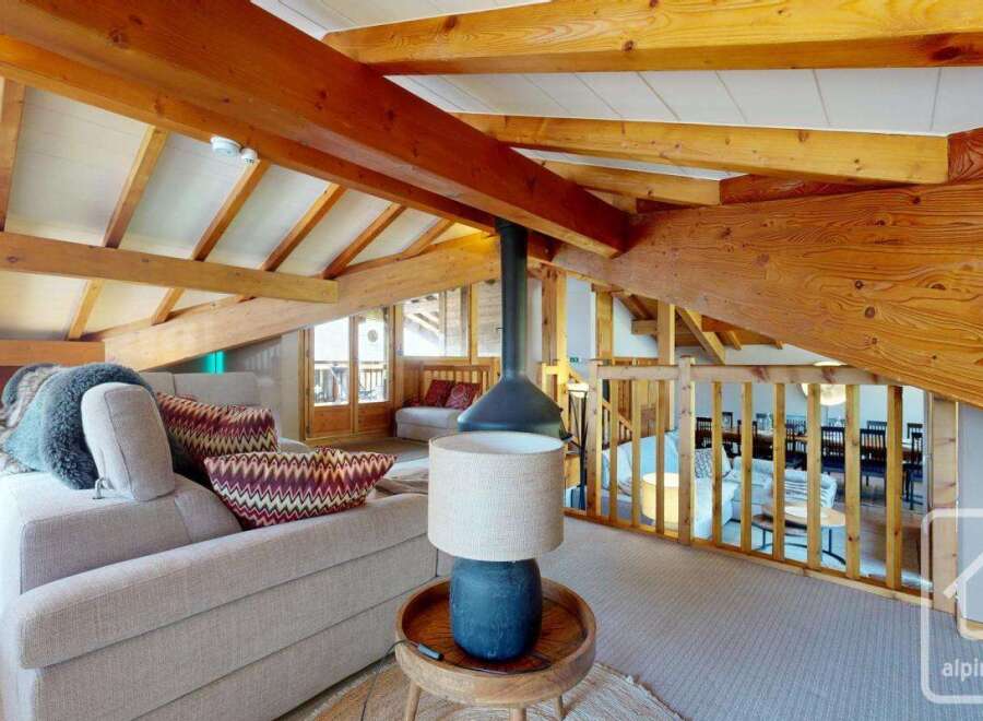 Experience the charm of this stunning property, featuring a cozy living area with a unique fireplace and exposed wooden beams.