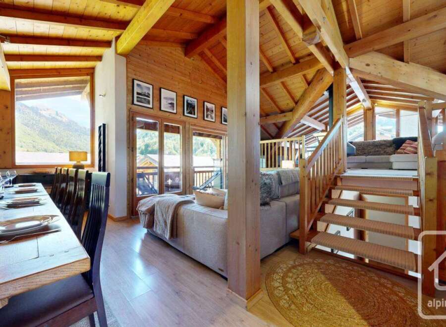 Experience luxury living in this stunning property, featuring a spacious dining area and a cozy living room.