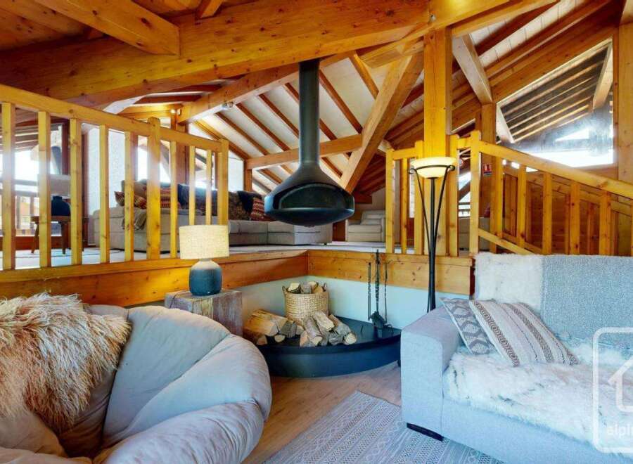 Experience luxury living in this stunning property featuring a unique fireplace and exposed wooden beams.