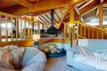 Experience luxury living in this stunning property featuring a unique fireplace and exposed wooden beams.