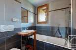 This modern bathroom features a sleek design with gray and black tiles, creating a sophisticated ambiance.