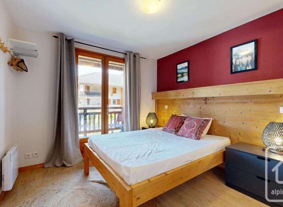 Discover the charm of this cozy bedroom, featuring a comfortable bed and stylish decor.