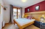 Discover the charm of this cozy bedroom, featuring a comfortable bed and stylish decor.