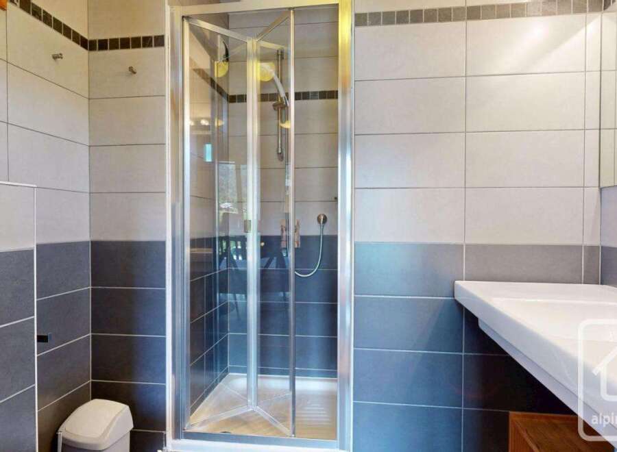 Step into a modern bathroom featuring a sleek glass shower enclosure.
