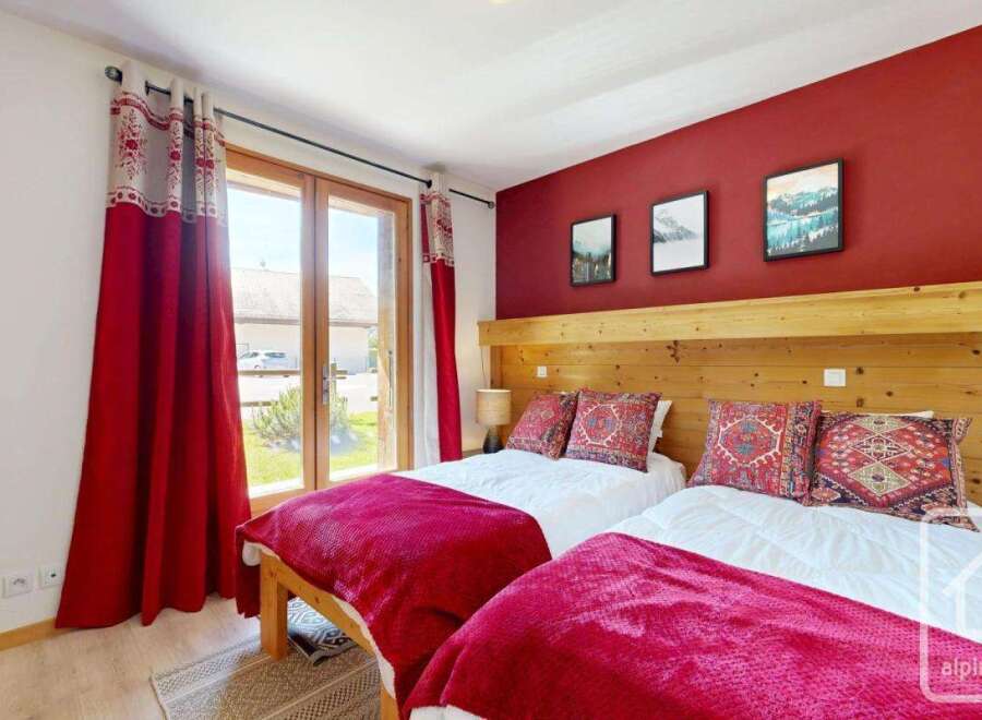 Discover the charm of this inviting bedroom, featuring two cozy beds perfect for a relaxing stay.
