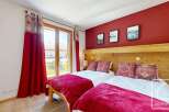 Discover the charm of this inviting bedroom, featuring two cozy beds perfect for a relaxing stay.